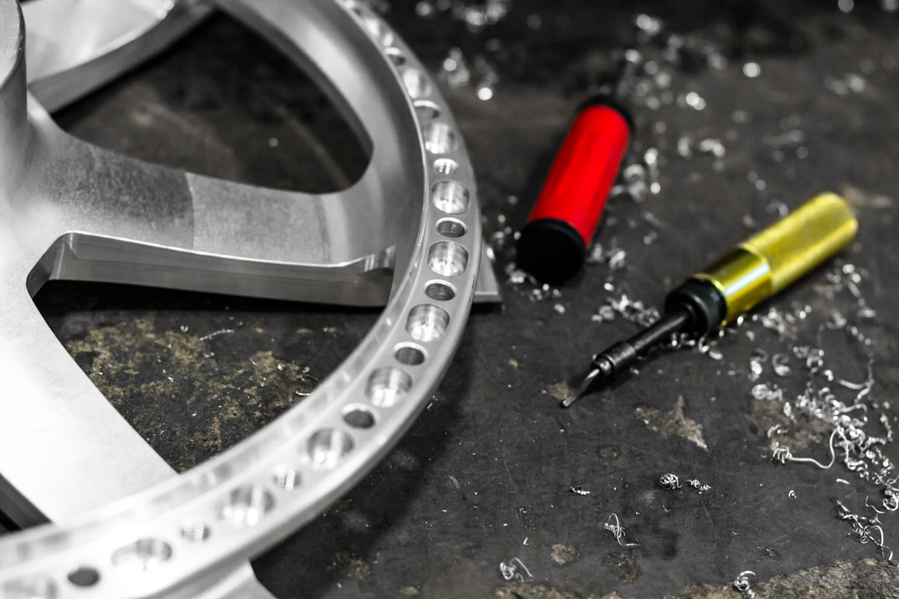 Machined spoke face with hand deburring tools