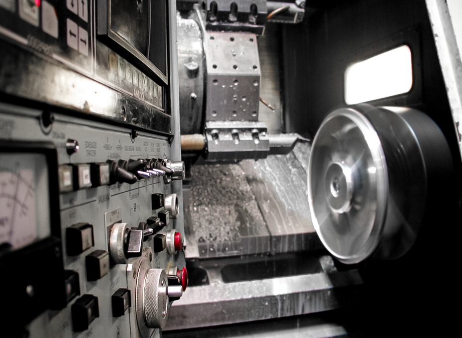 CNC lathe machining a forged wheel blank